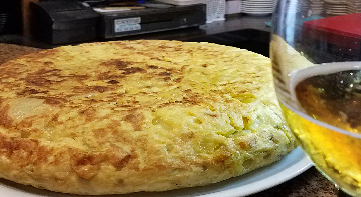 Granada, Spain. A tortilla Español, potato and egg, with or without onion, sometimes runny inside, sometimes not. Allays great and inexpensive.